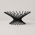 Black metal chair with a modern design on a light gray background