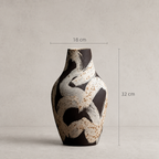 Ceramic vase with abstract design and measurements on a neutral background