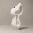 Abstract white ceramic vase on a beige background