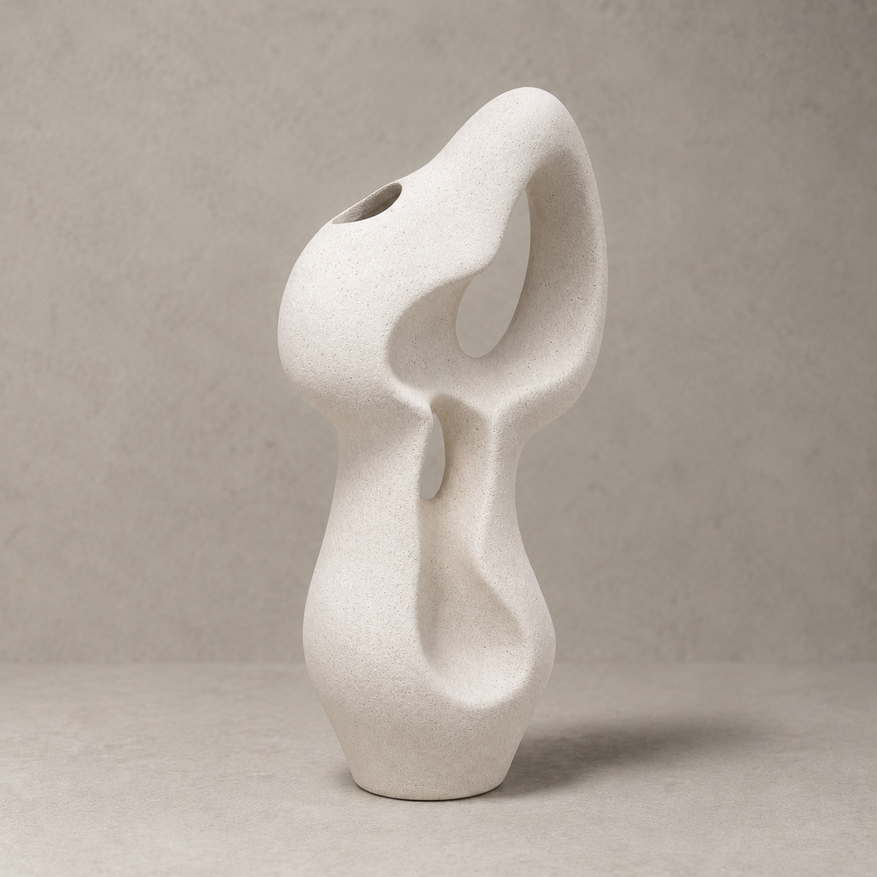 Abstract white ceramic vase on a beige background